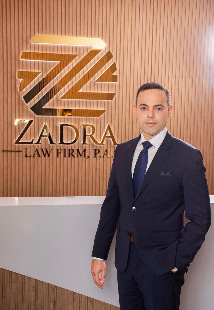Abogado de Zadra Law Firm, P.A. junto al logotipo de la firma